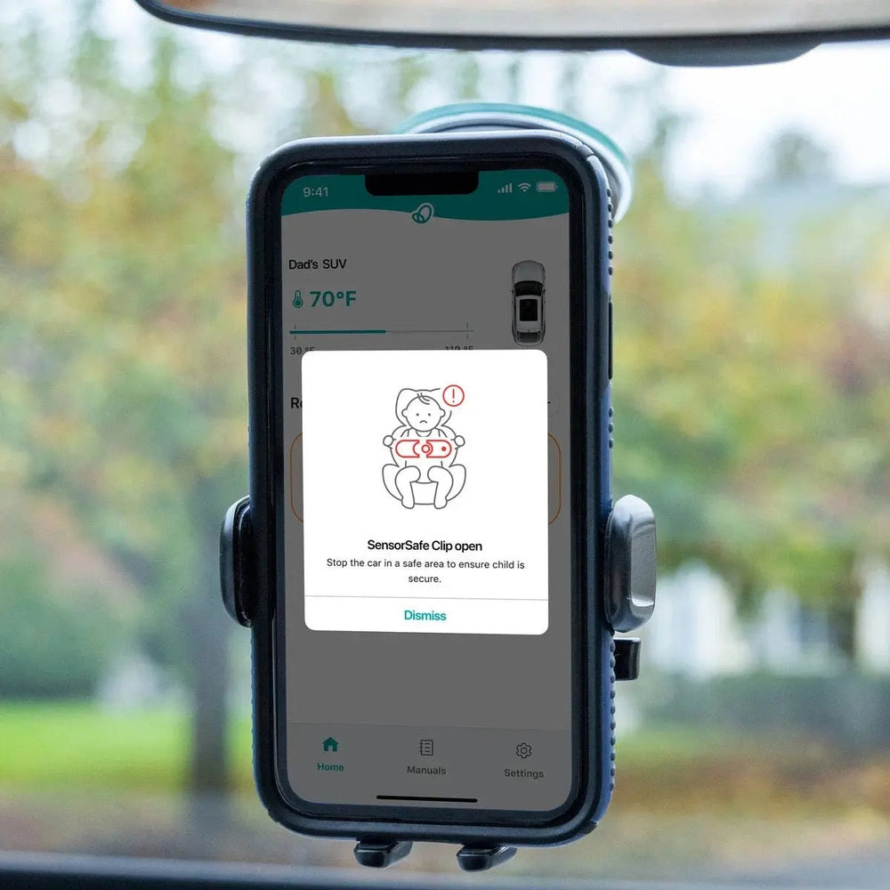Evenflo Revolve360 Extend All-In-One Rotational Car Seat with SensorSafe; smartphone on car mount shows SensorSafe alert.