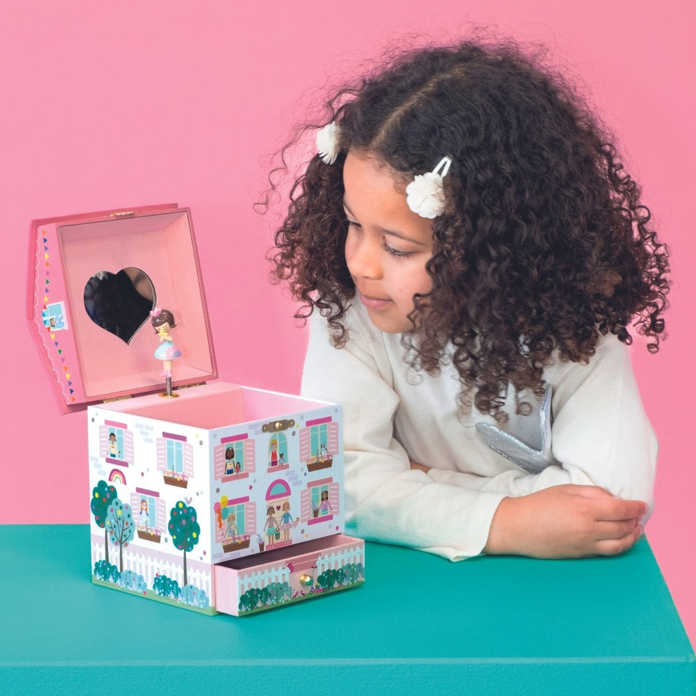 Floss And Rock Dolls House Jewelry Box, pink multi-tiered box opened to reveal a ballerina figurine as a girl looks on.
