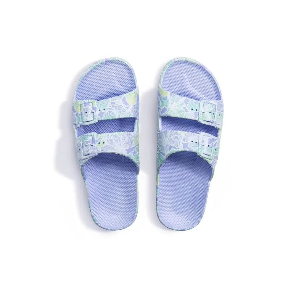 Freedom Moses Prints Adult Aloha Hydra lavender sandals with palm-print straps and dual adjustable Velcro straps.