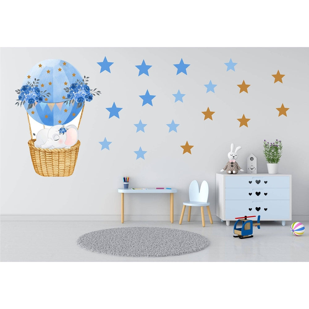 Hello Beautiful Designs sleeping elephant on a blue hot-air balloon wall sticker with blue and gold stars for nursery