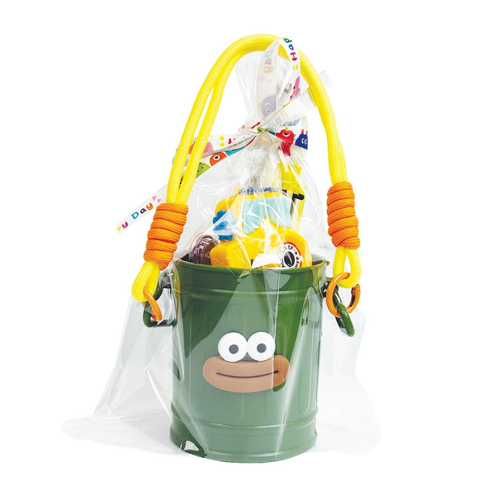 Holiday Stationery Gift Basket by baby enRoute, green monkey-face bucket with yellow rope handles and clear bag of toys.