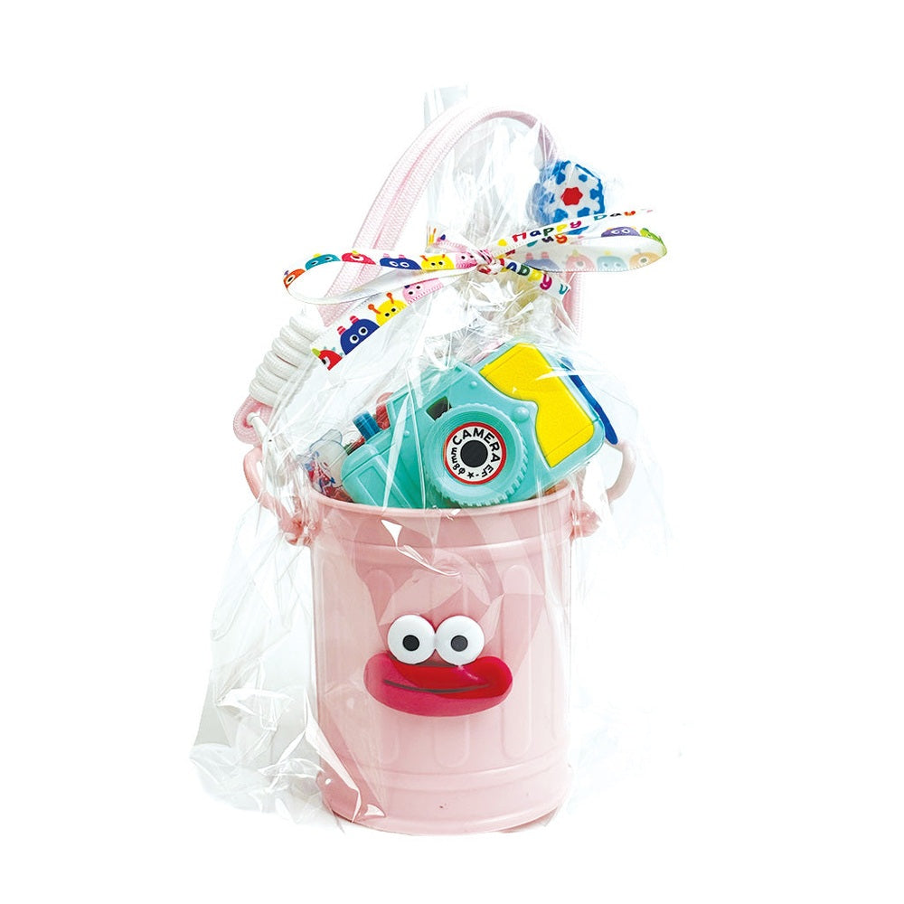 Holiday Stationery Gift Basket by baby enRoute: pink bucket with a smile, wrapped in clear film with rainbow ribbon and toys.