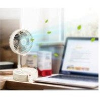 I2 convertible tabletop-to-floor fan with lithium battery on a wooden desk beside a laptop