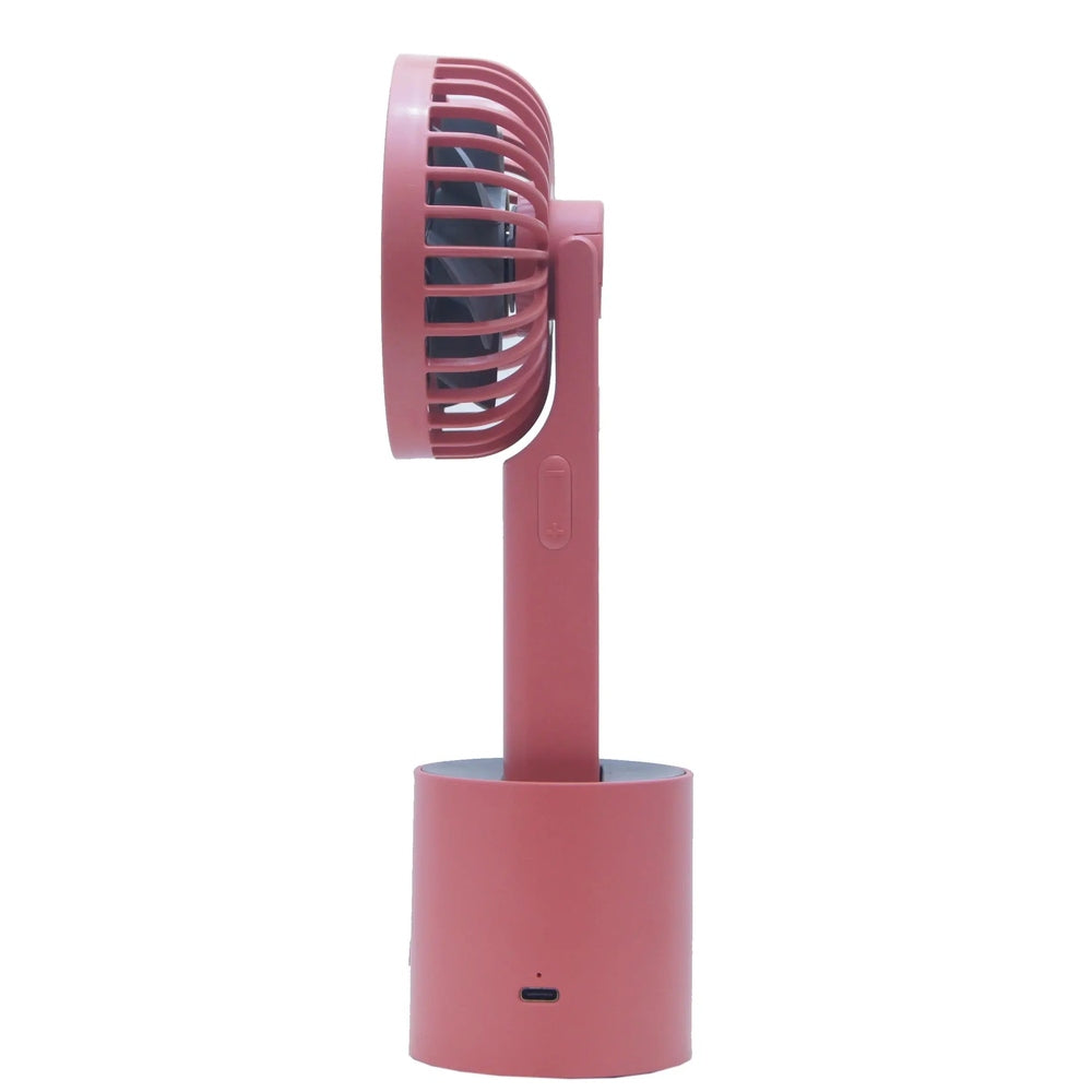 I2 Handheld 5-Speed Lithium Battery Fan in pink perched on charging base with USB-C port visible.