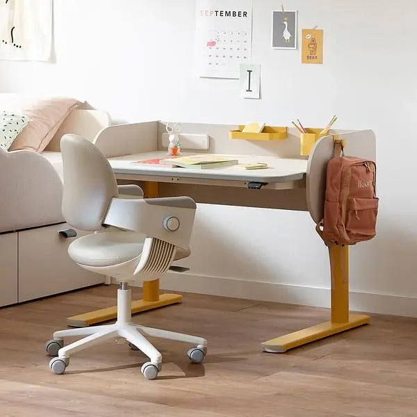 Iloom Jerome Motion Desk with yellow frame and white top; backpack on leg