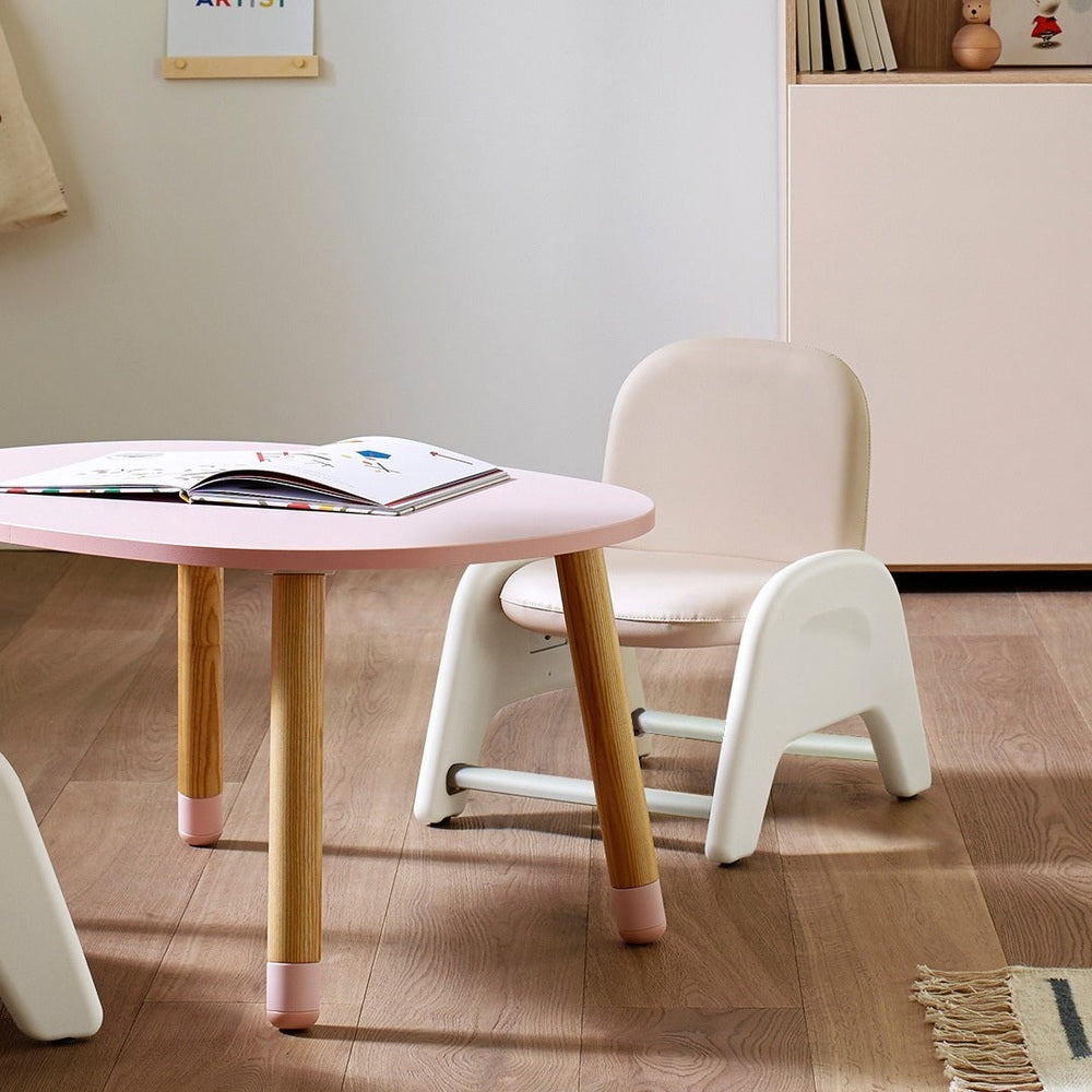 Iloom Atti I Chair, pink seat with wooden legs, a cozy, safe kid seating option in a bright playroom.