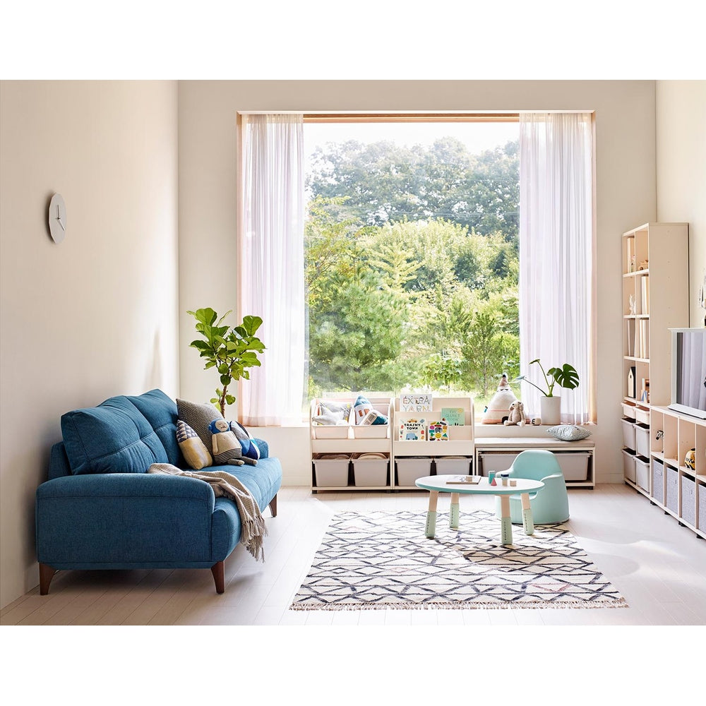 ILOOM Eddi Kids 6-Story Bookshelf 950W in white, with open cubbies and toy bins organizing books in a sunlit playroom.