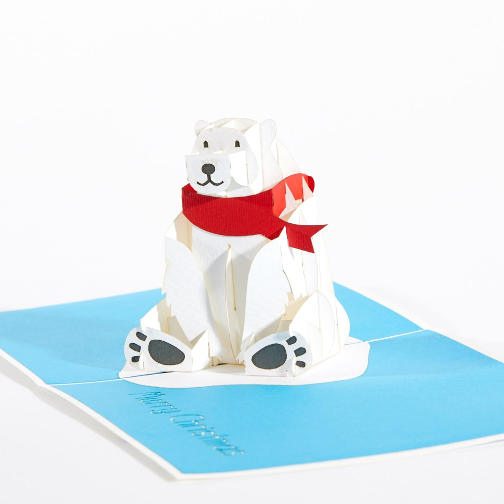 Intricate Greetings Polar Bear pop-up card, white bear with red scarf standing upright on a blue card.