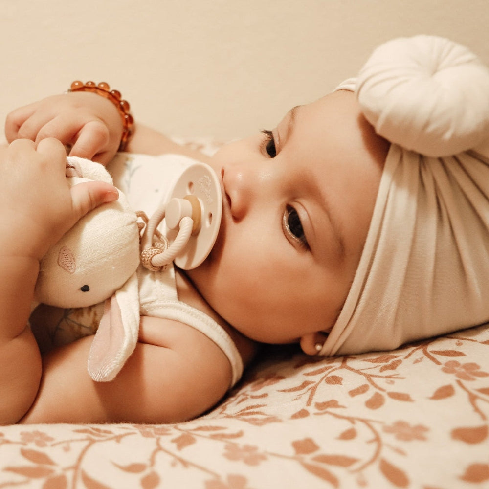 Itzy Ritzy Bitzy Pal natural rubber pacifier with beige plush bunny and tubing
