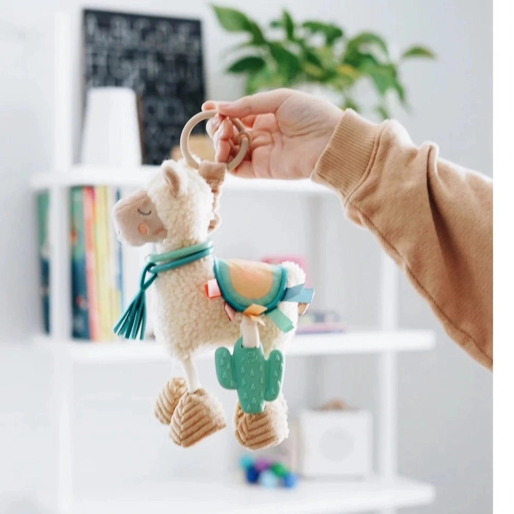 Itzy Ritzy Itzy Friends Link & Love Activity Plush llama with cream fleece and teal saddle