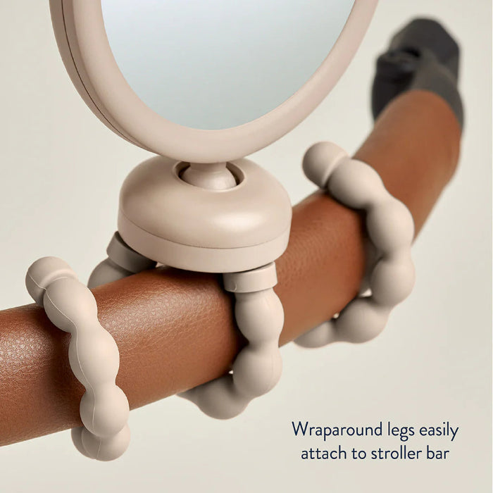 Itzy Ritzy Itzy Peek Stroller Mirror with beige wraparound bead straps on a stroller bar