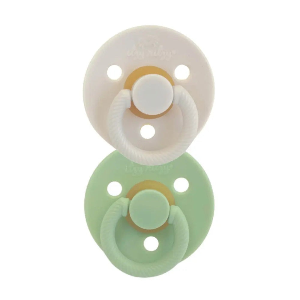 Itzy Ritzy Itzy Soother Natural Rubber Pacifier Set with two pastel pacifiers in white and mint, each featuring a visible loop handle.