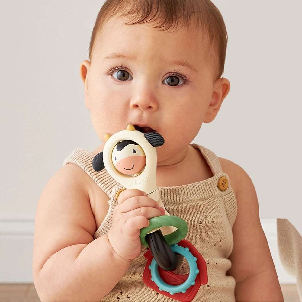 Itzy Ritzy Itzy Spinner teething toy with cow-face charm and bright stacked rings for babies