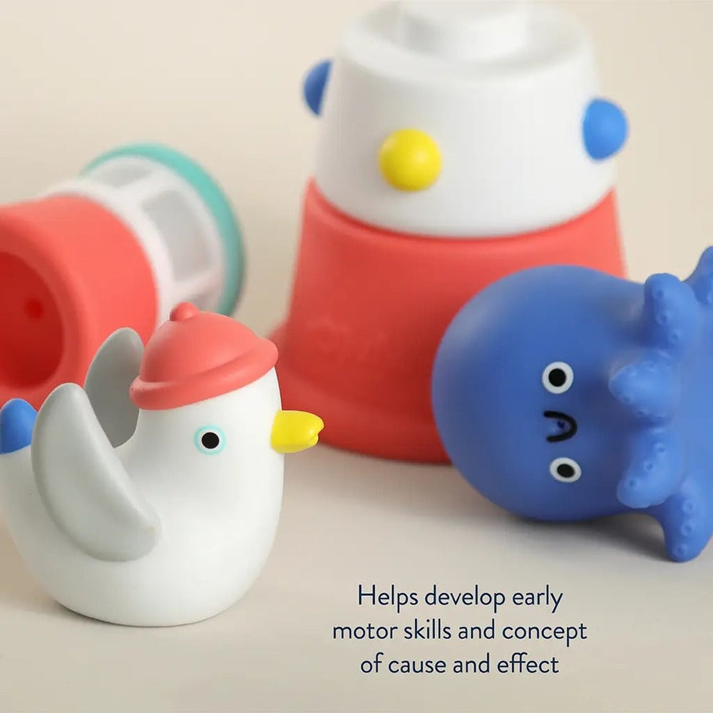 Itzy Ritzy Stack & Squirt bath toy set with a white chick, blue whale, and red–white stackable cups.