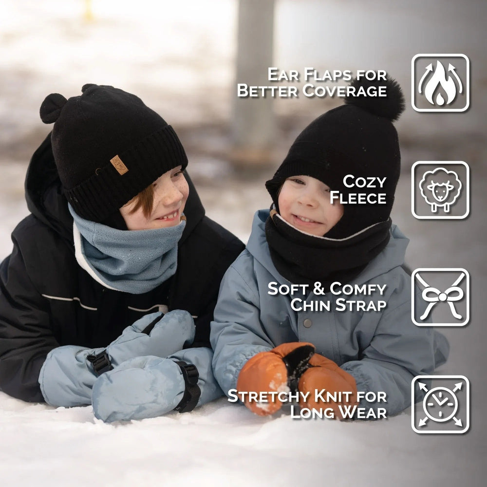 Jan & Jul Kids Bear Knit Hats Jet Black worn by two smiling kids in winter, showcasing ear flaps, cozy fleece, and stretchy knit.