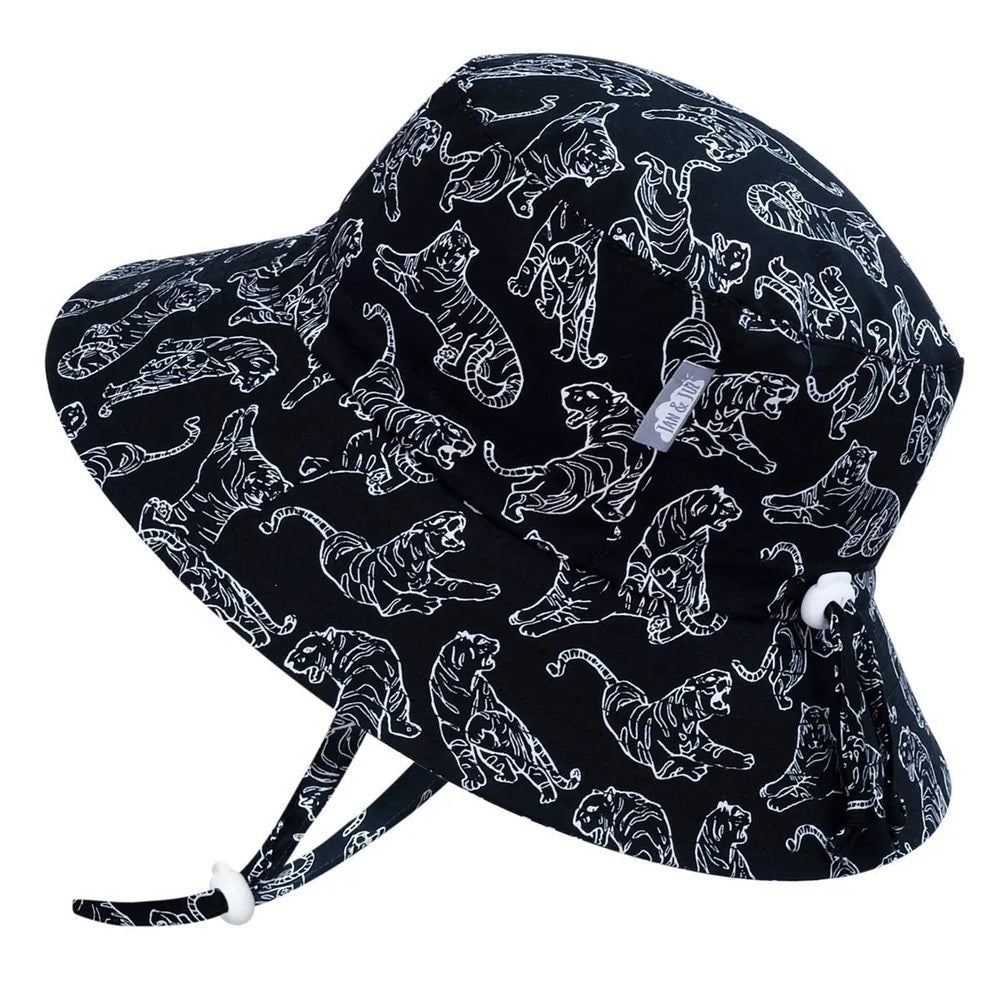 Jan & Jul Kids Cotton Bucket Hat Tiger in black with white tiger print, adjustable chin strap shown under chin securing fit.