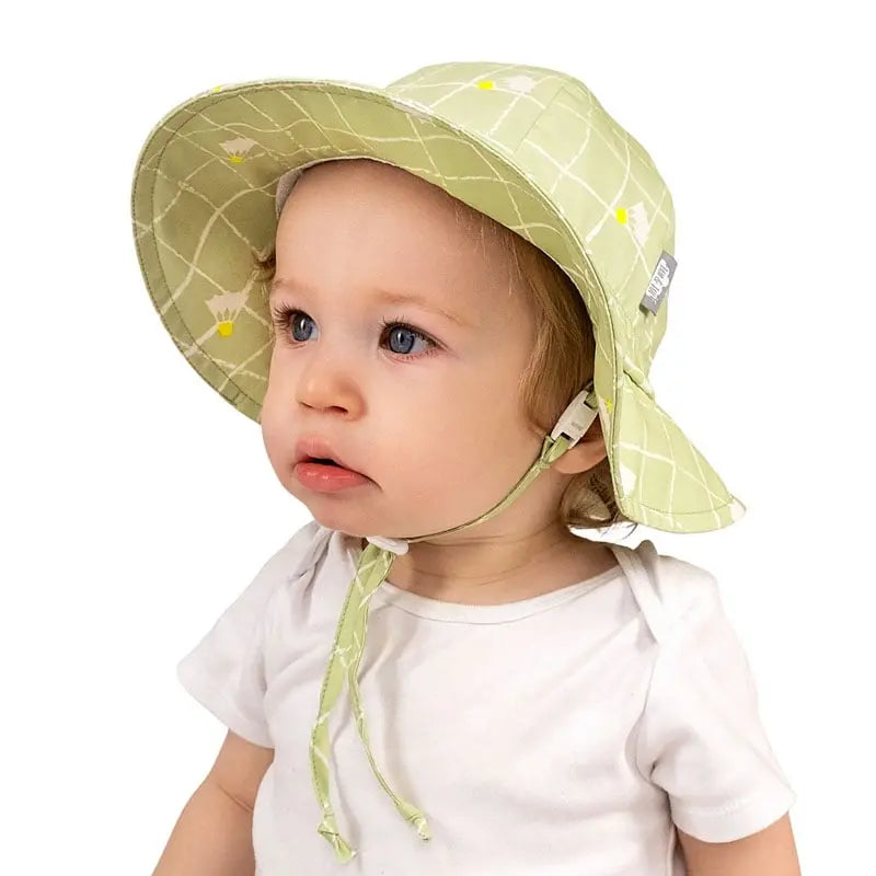 Jan & Jul Kids Cotton Floppy Hat Birdie in light green, wide brim with chin ties on a toddler.