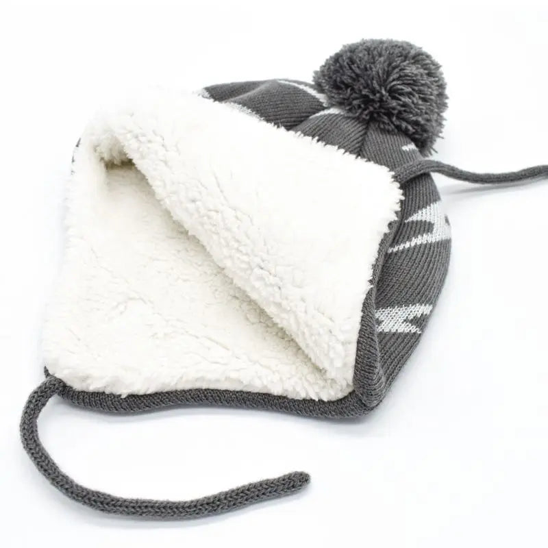 Jan & Jul Kids Knitted Beanie Hat Grey Lighting Bolt, folded to show plush white sherpa lining and pom-pom.