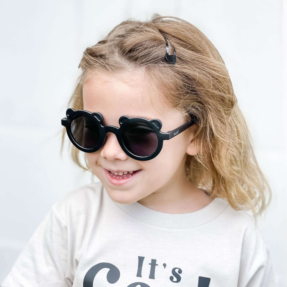 Jan & Jul Kids Polarized Bear Sunglasses, black bear-shaped round frames worn by smiling child