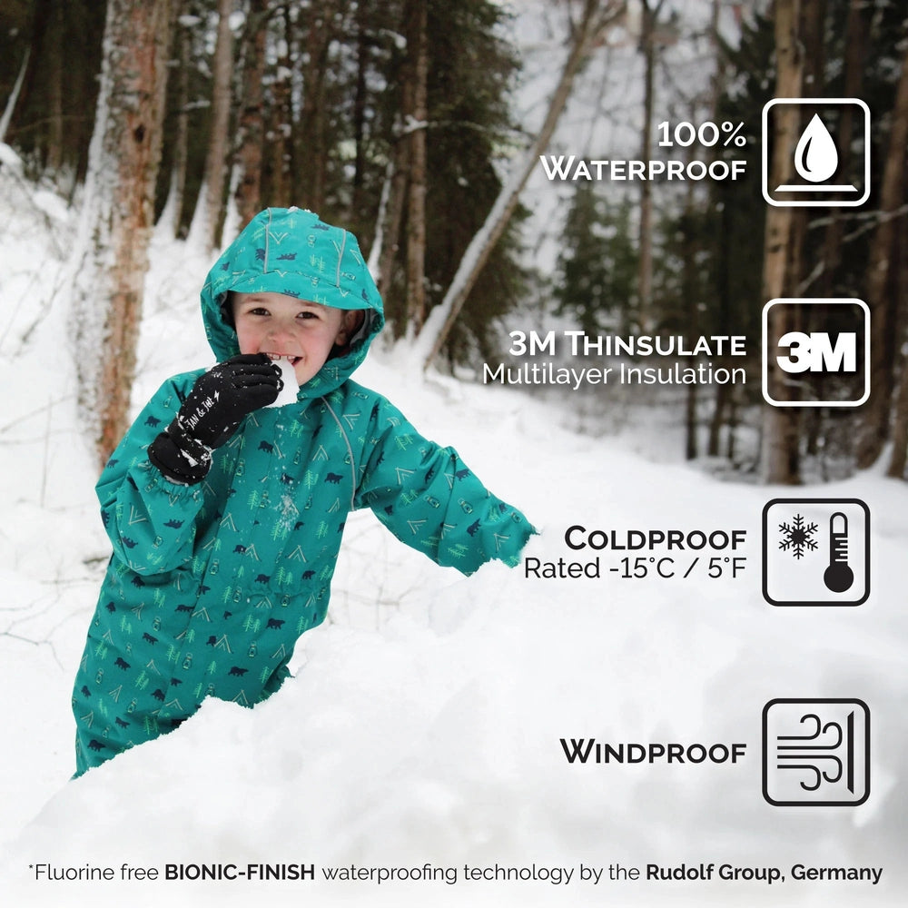 Jan & Jul Kids Waterproof Snow Gloves Neon Peaks; child in teal snow gear grins in snow, proving warm, waterproof, windproof gloves.