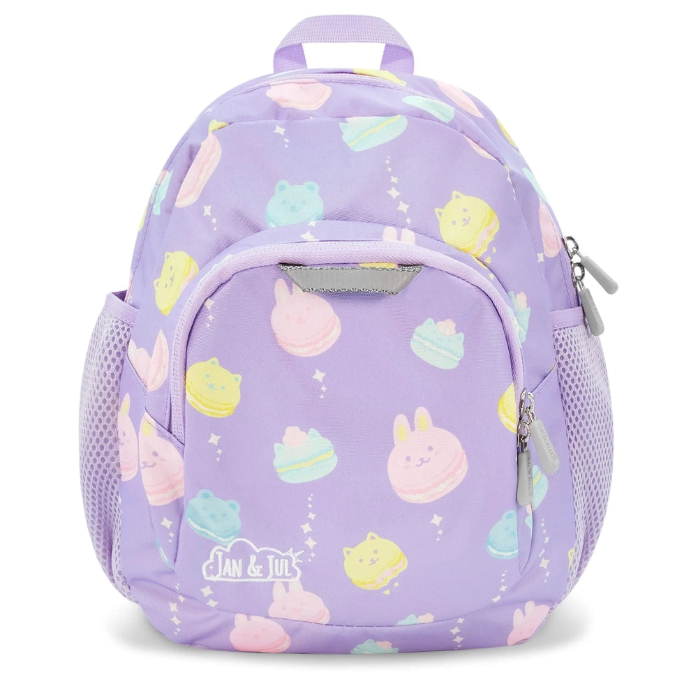 Jan & Jul Kids Mini Backpack in lavender with pastel dessert print, showing front zip pocket and mesh side pockets.