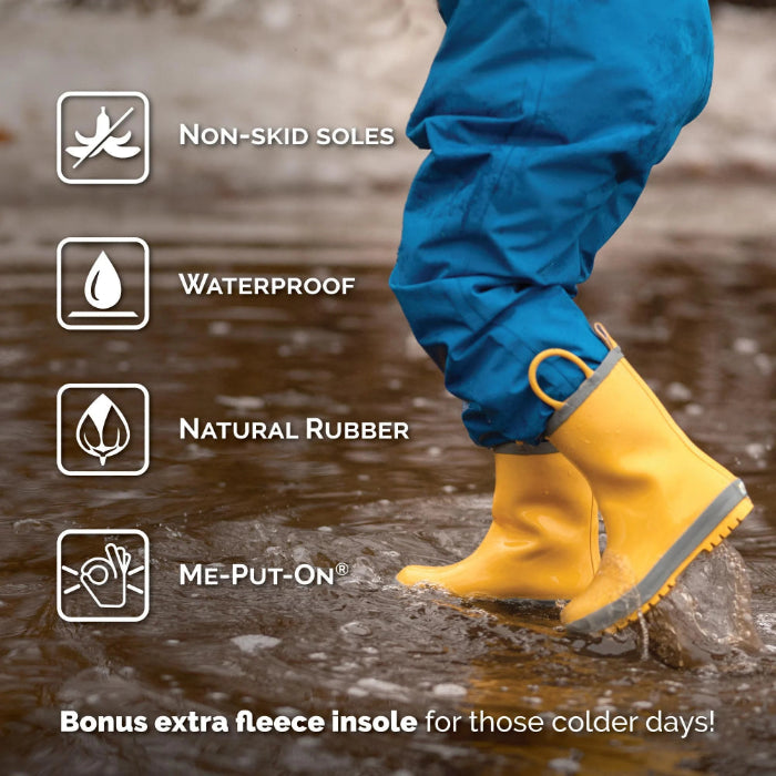 JAN & JUL Puddle Dry Rain Boots With Handle Macarons for babies; yellow natural rubber waterproof boots with non-skid soles, shown splashing a puddle.
