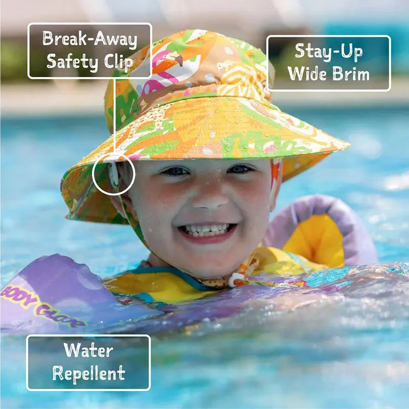 JAN & JUL Water Repellent Bucket Hat Seagull, colorful print, worn by a smiling toddler in a pool.