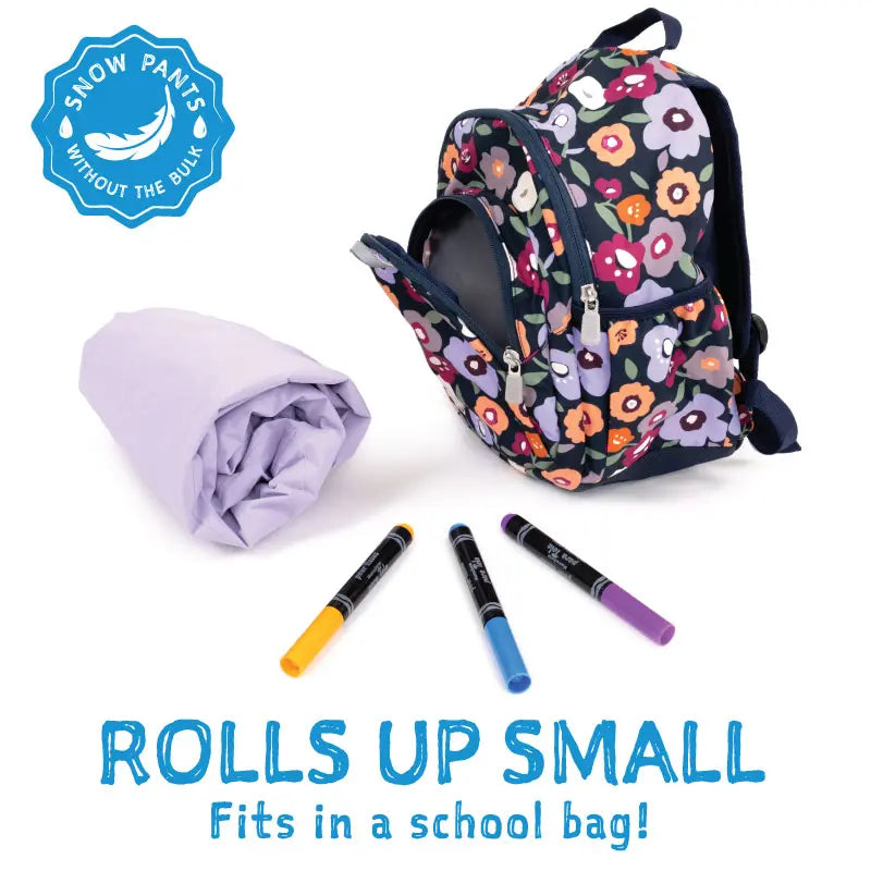 Jan & Jul Waterproof Cozy Dry Rain Pants Black; rolls up small for easy storage beside a floral backpack.