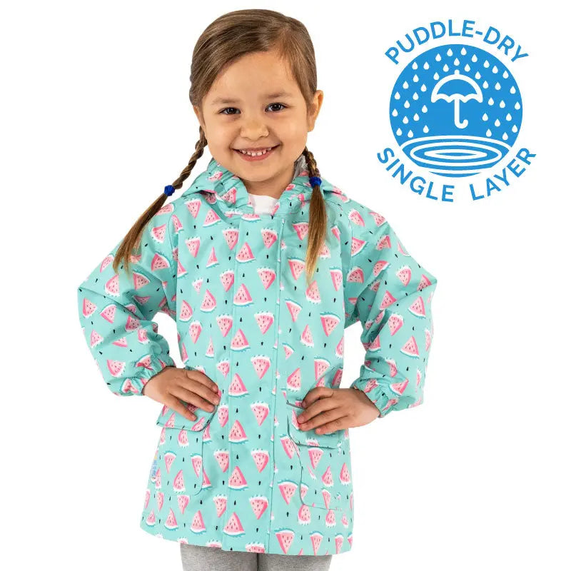JAN & JUL Waterproof Puddle Dry Rain Jacket Watermelon worn by a smiling toddler in aqua with watermelon print, showing puddle-dry protection.
