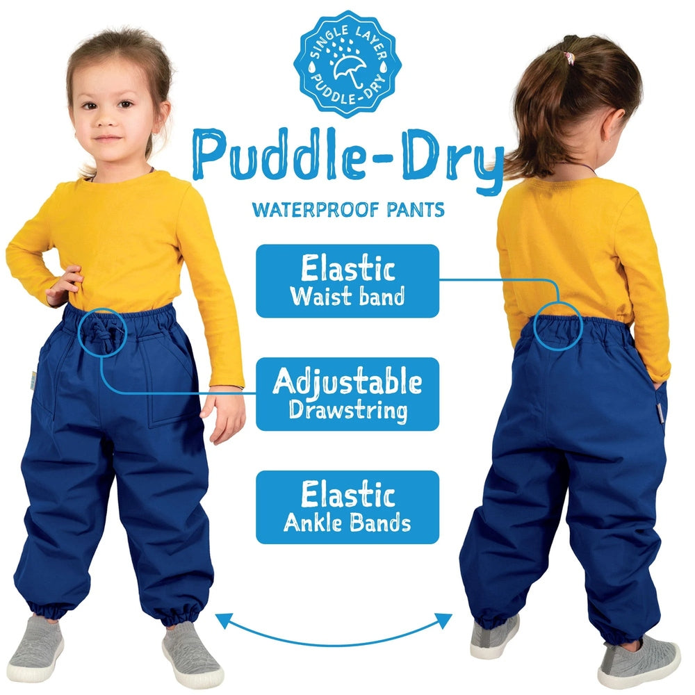 JAN & JUL Waterproof Puddle-Dry rain pants dusty mint worn by a child, elastic waist with drawstring and elastic ankle bands.