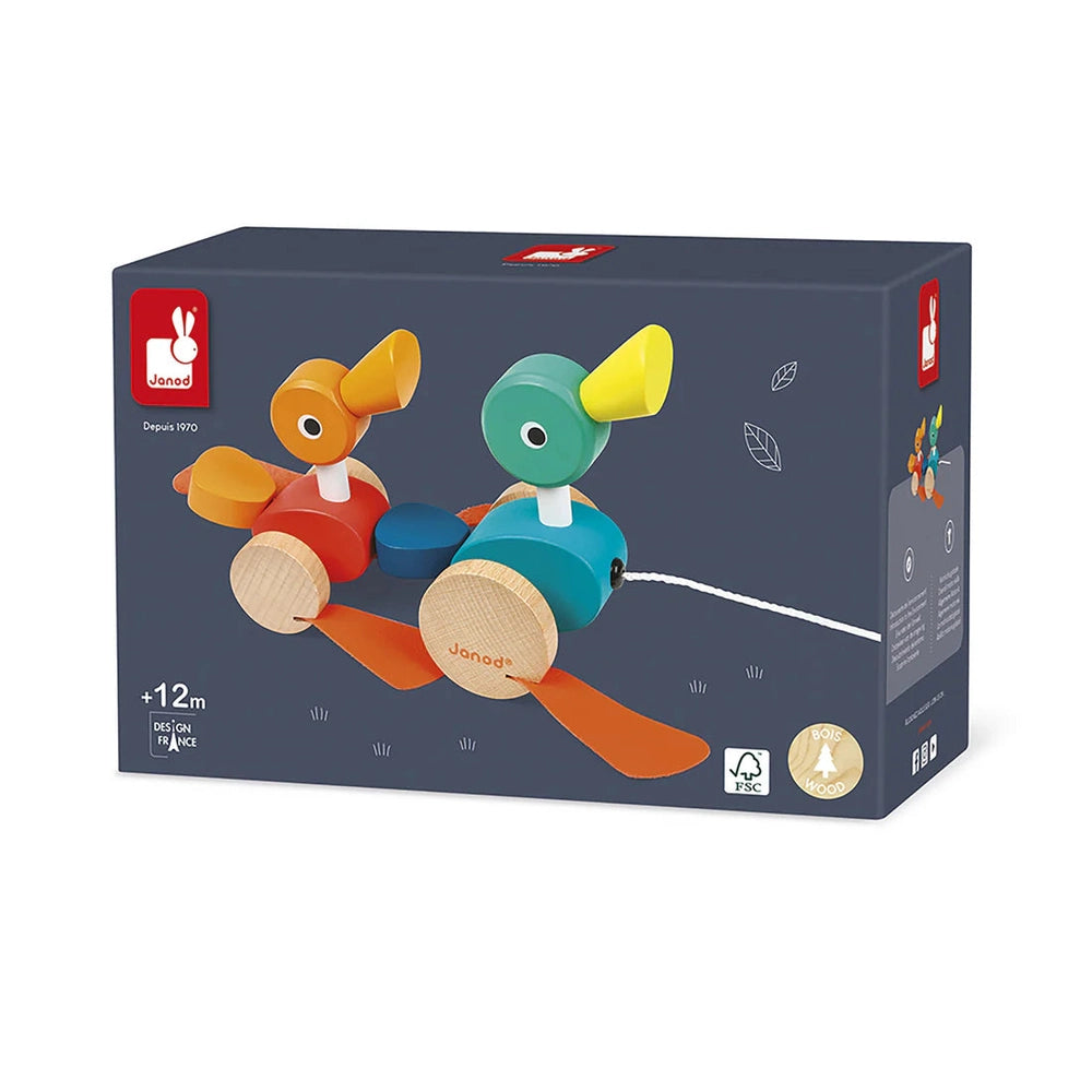 Janod Zigolos Pull Along Ducks wooden toy with two colorful ducks on wheels being pulled by a string.