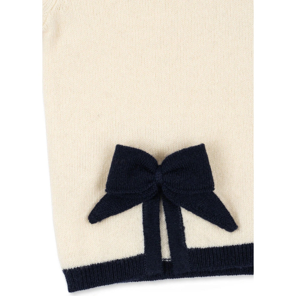 Konges Slojd Alette Cardigan Etoile in cream knit with navy bow at hem, baby top.