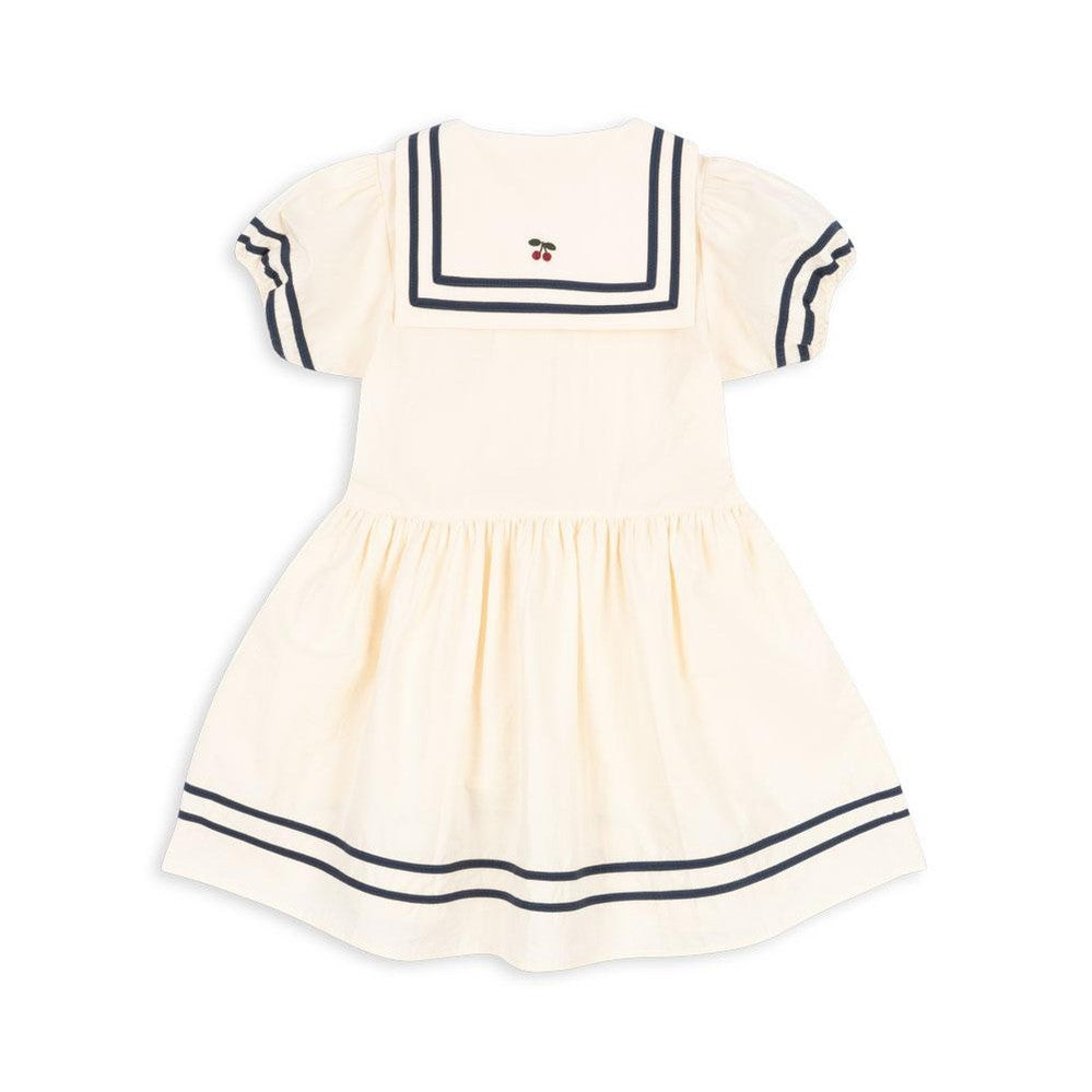 Konges Slojd Allie Sailor Dress optic white with navy sailor collar stripes, puff sleeves, and gathered waist.