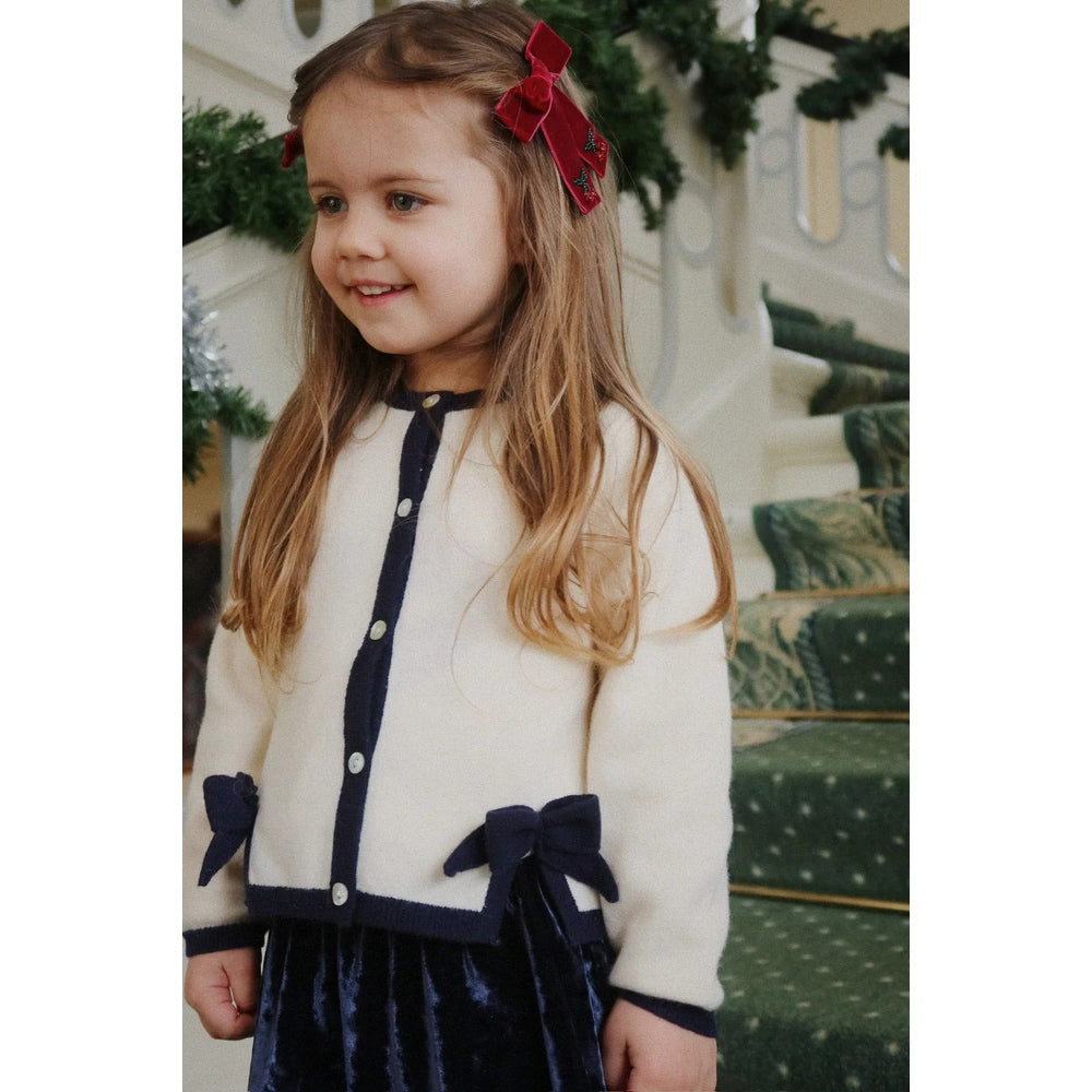 Konges Slojd Carlito Skirt Navy Blazer on a smiling girl wearing a cream cardigan with navy trim.