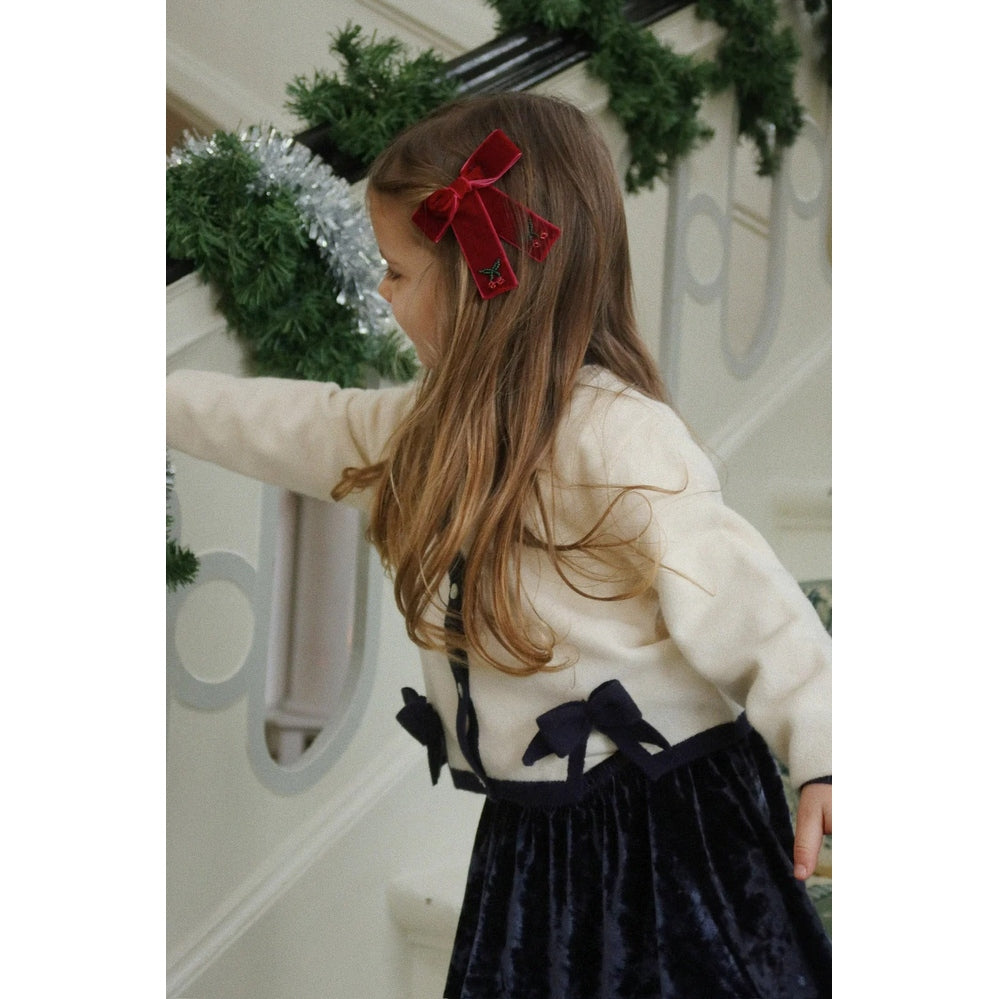 Konges Slojd Carlito Skirt Navy Blazer worn by a girl in a cream top; navy velvet skirt with navy bows.