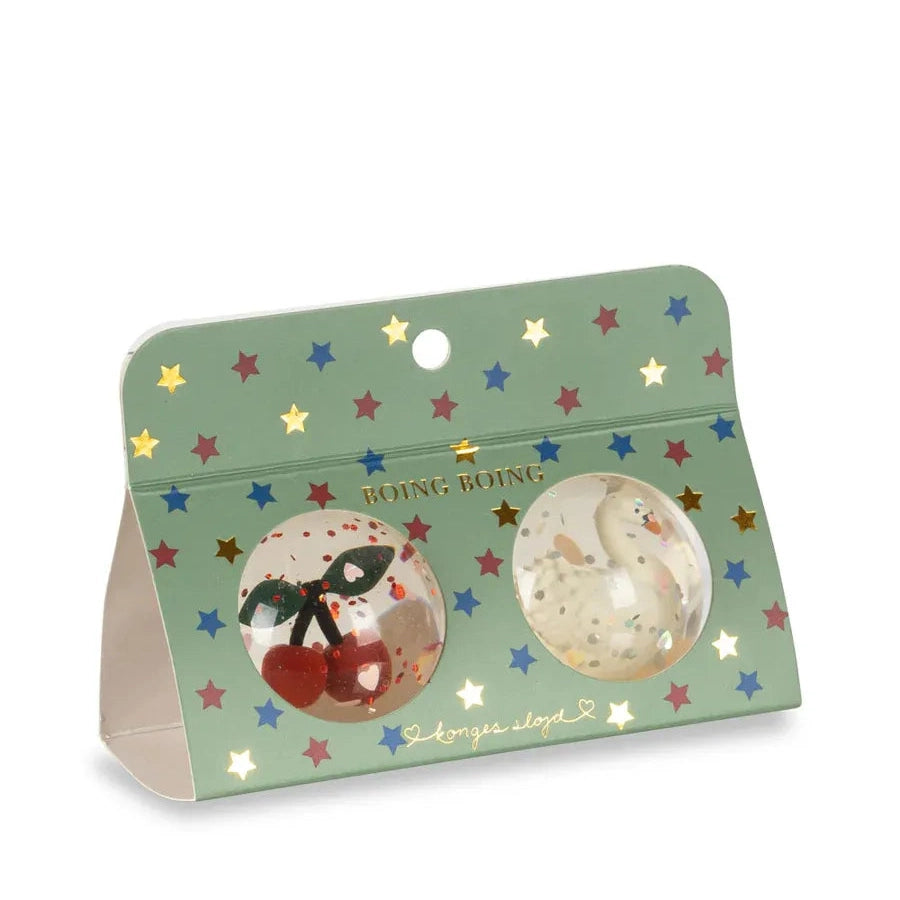 Konges Slojd Glitter Bouncing Ball Set Cherry/Swan in starry green packaging with two clear glitter balls visible.