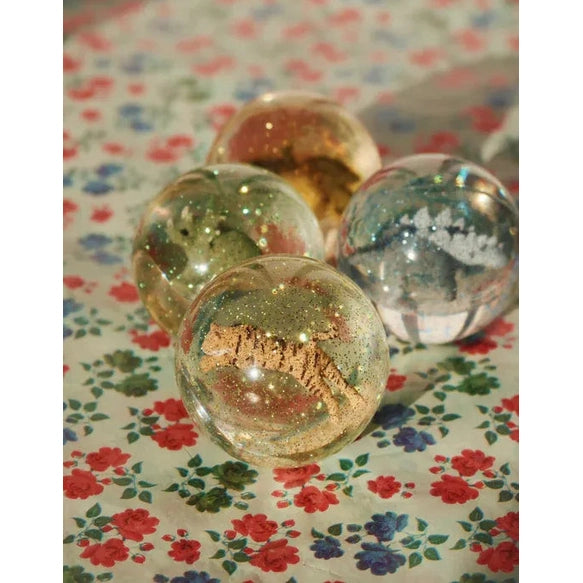 Konges Slojd Glitter Bouncing Ball Set Lemon/Tiger: clear glitter spheres featuring tigers, displayed on a floral tablecloth.
