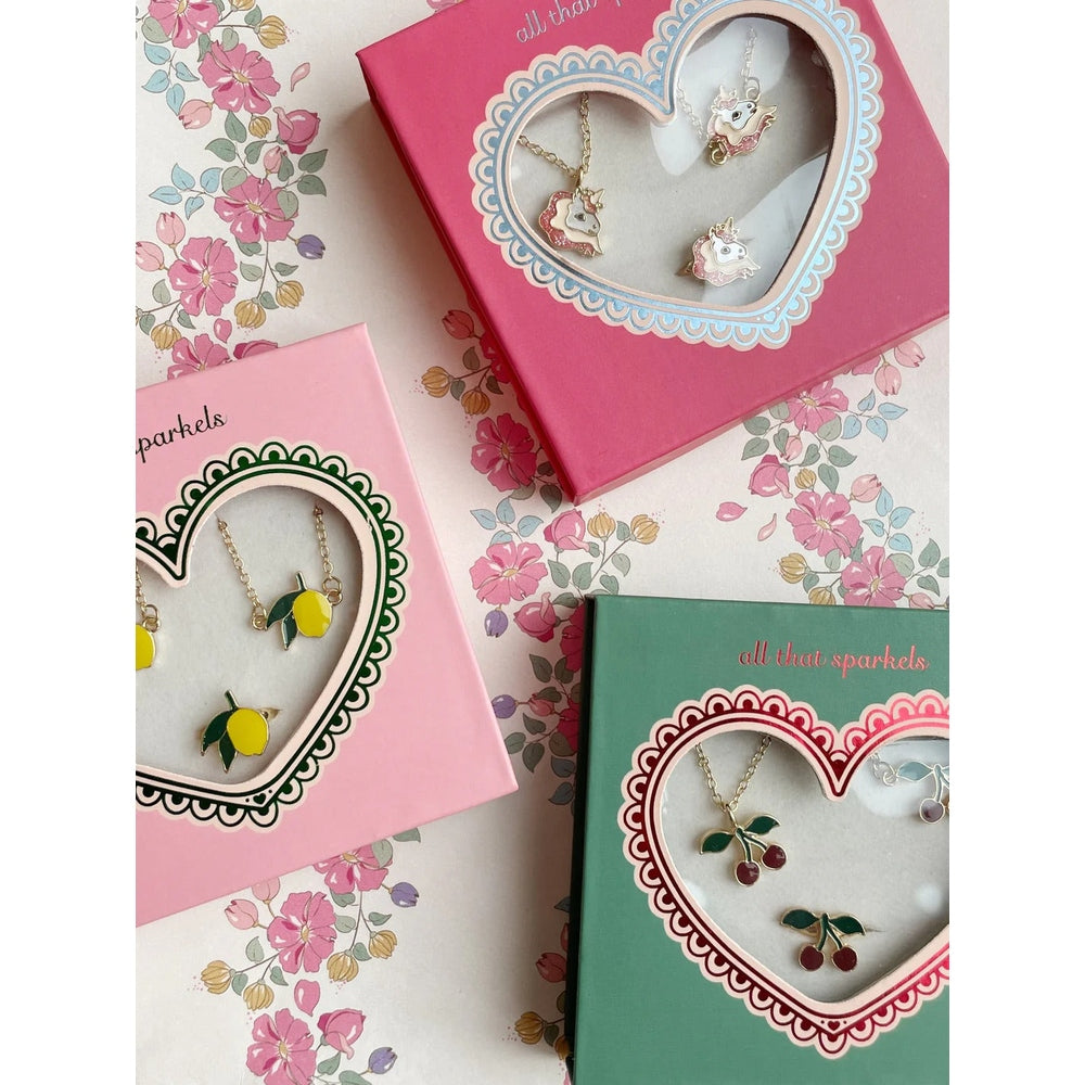 Konges Slojd Jewelry Set: three pastel boxed sets with heart windows, unicorn and fruit charm necklaces.