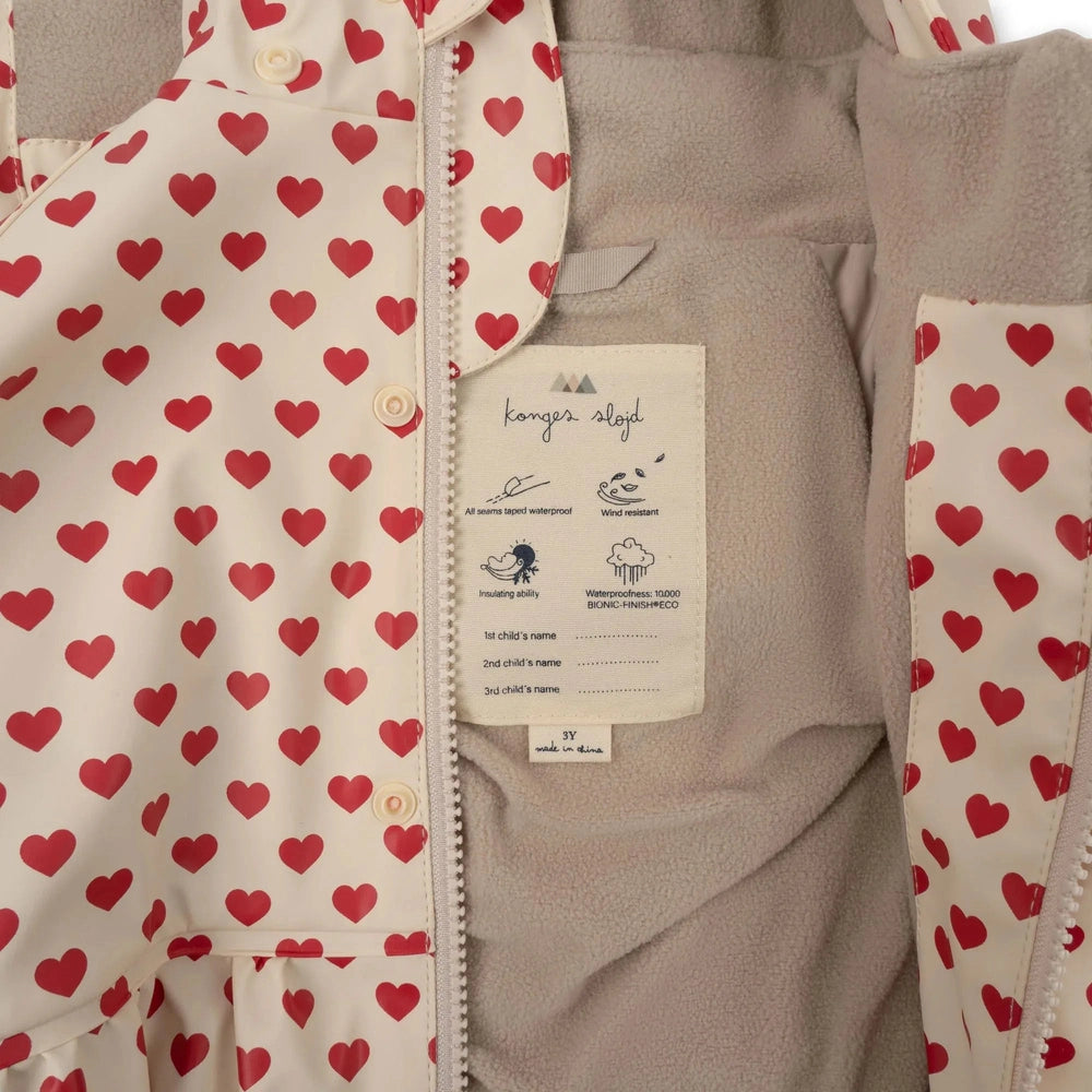 Konges Slojd Rainy Palme Set Coeur Rouge baby outfit with cream heart-print outer, zipper, and cozy fleece lining.