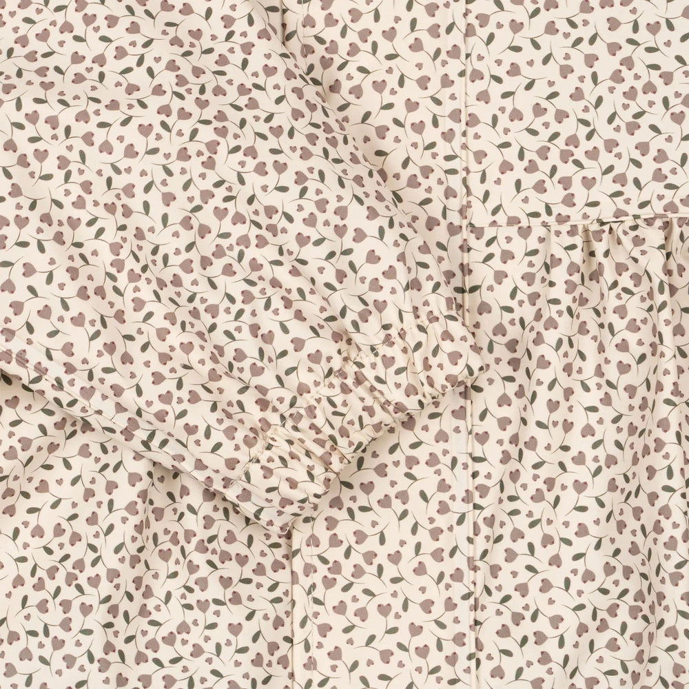 Konges Slojd Rainy Palme Set Milk Tank; cream fabric with mauve leaf print, showing gathered sleeve detail.