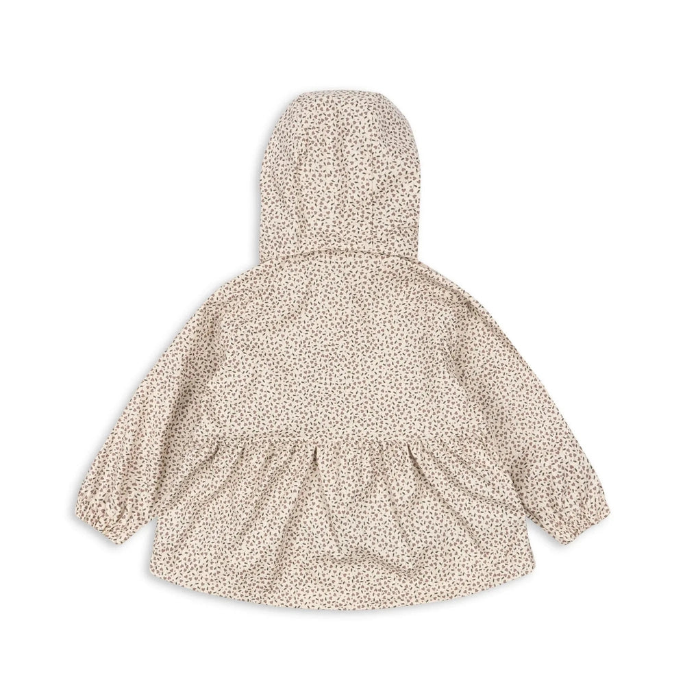 Konges Slojd Rainy Palme Set Milk Tank baby raincoat with hood in beige floral print, back view.