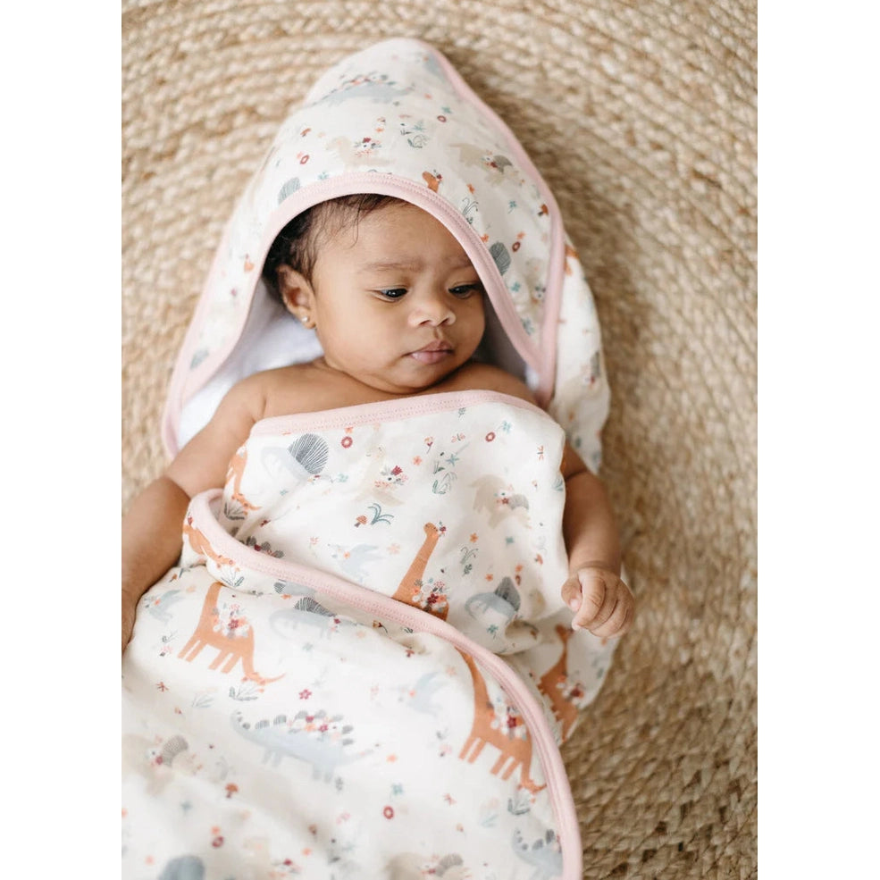 Loulou Lollipop Hooded Towel Set: baby cozily wrapped in a white towel with pastel animal print and pink trim.