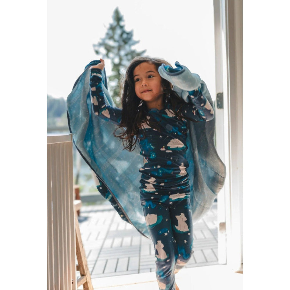 Loulou Lollipop Long Sleeve Pajama Set Stargazing Bear, blue starry print, child wraps in a cozy blanket.