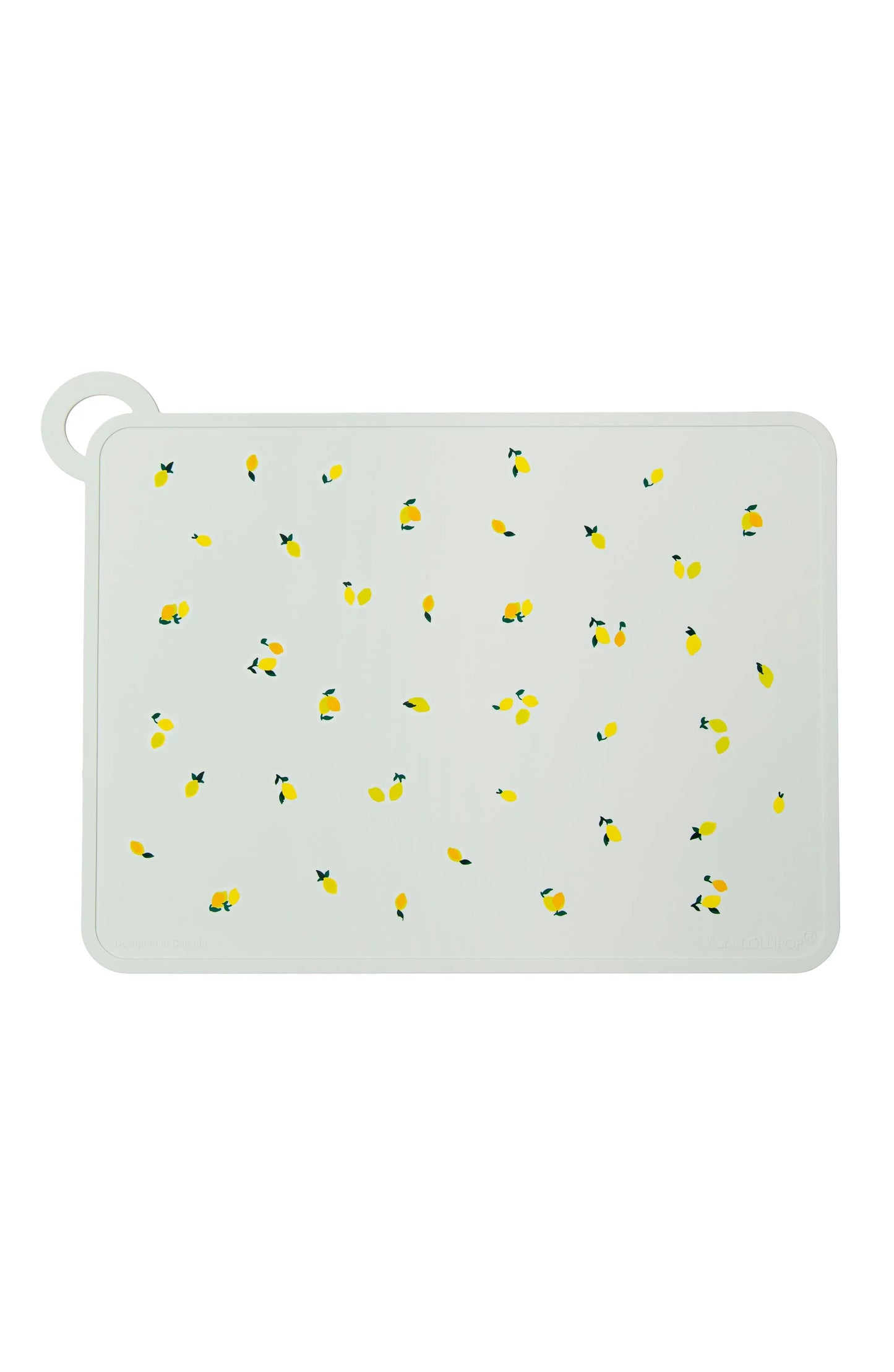 LOULOU LOLLIPOP Silicone Placemat, white with yellow lemon print, laid flat to showcase its silicone surface.