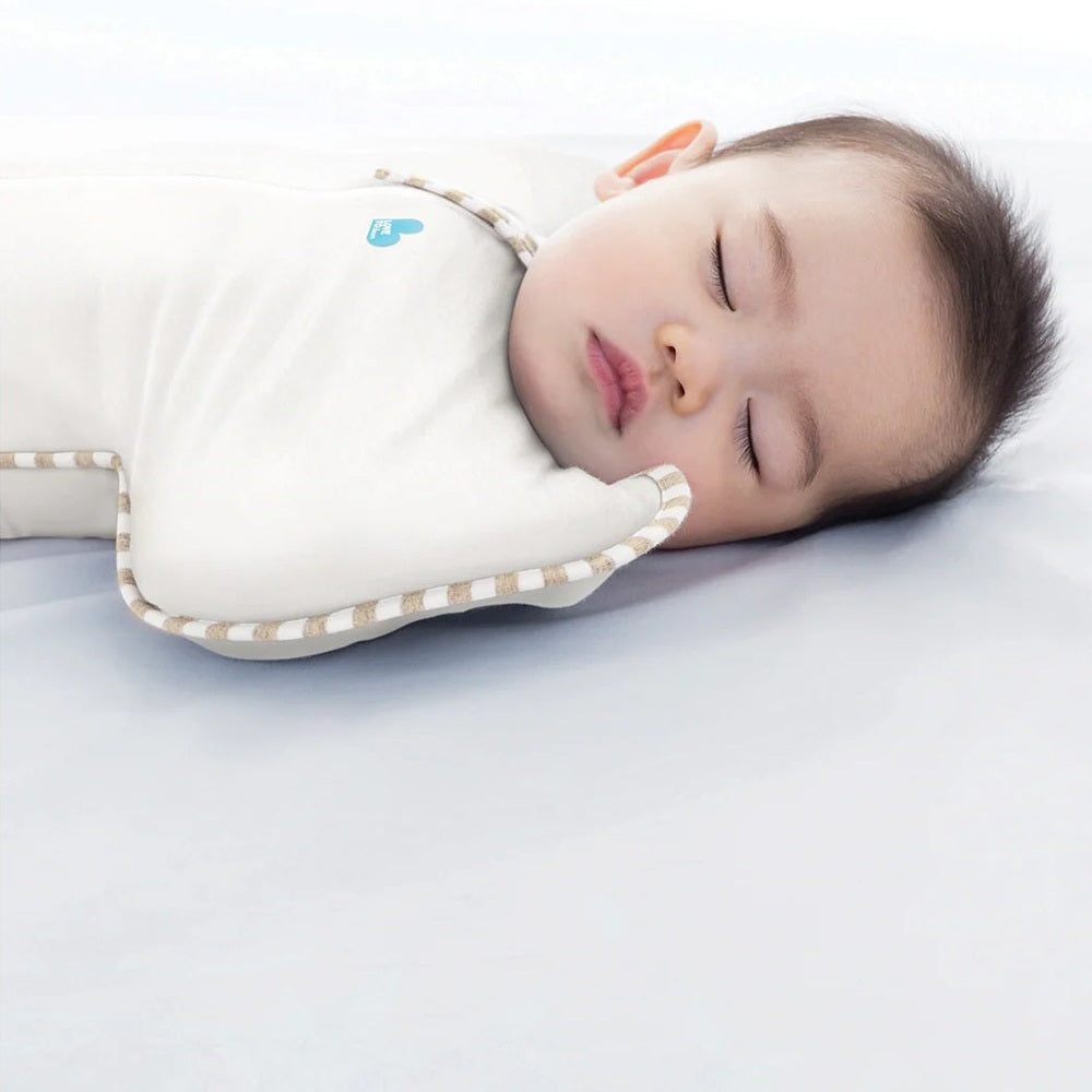Love To Dream Swaddle Up Original Cotton 1.0 Tog Cream baby swaddle; baby sleeps soundly in cream cotton.