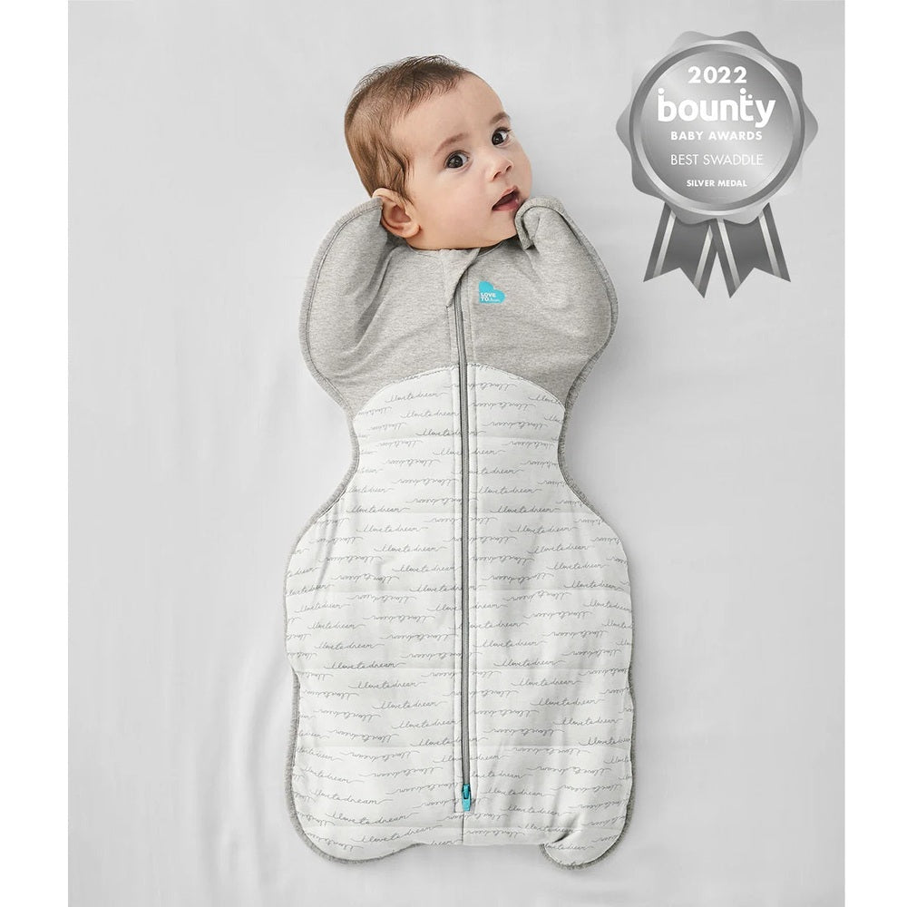 Love To Dream Swaddle Up Quilted Cotton 2.5 Tog Dreamer White: baby swaddled with arms up in gray upper and white quilted lower.