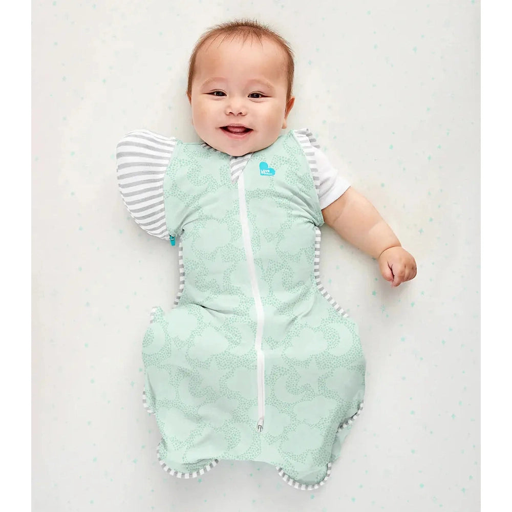 Love To Dream Swaddle Up Transition Bag Organic Cotton 1.0 Tog Mint, baby smiling as the zip-front design keeps arms snug.