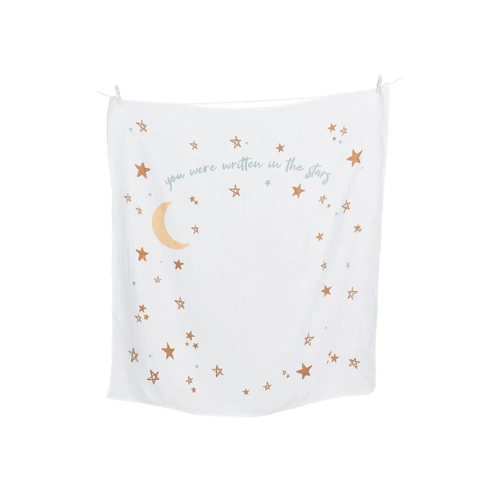 Lulujo Baby's 1st Year Set banner, white fabric with gold stars and crescent moon, hung with clothespins.