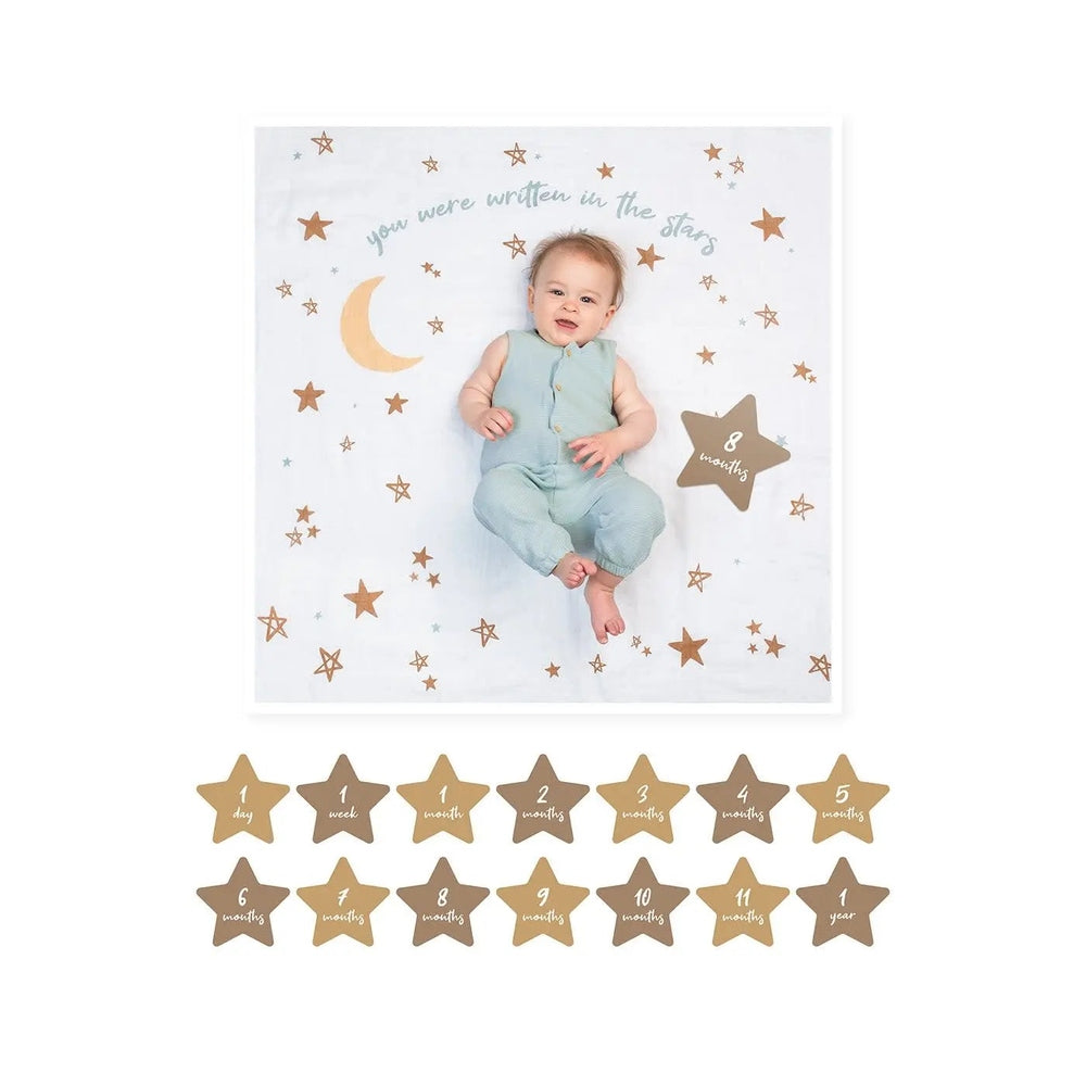 Lulujo Baby's 1St Year Set: baby in mint romper on a starry white blanket with gold milestone stars.