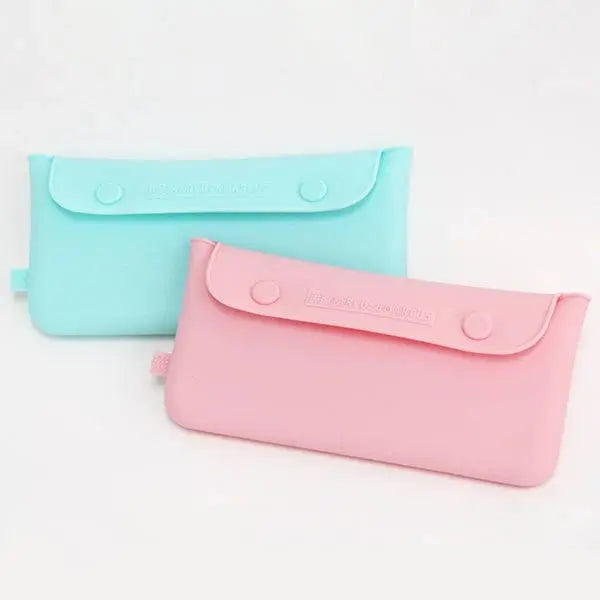Marcus & Marcus Cutlery Pouch, pastel blue and pink, with snap closures shown laying side by side for on-the-go feeding.